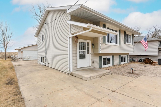 split level home featuring a garage and a patio