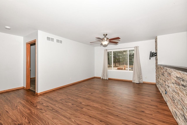 unfurnished room with ceiling fan and dark hardwood / wood-style floors