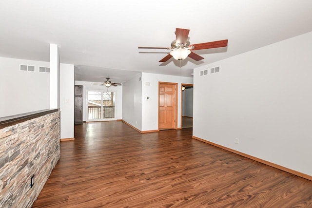 unfurnished living room featuring ceiling fan and dark hardwood / wood-style flooring