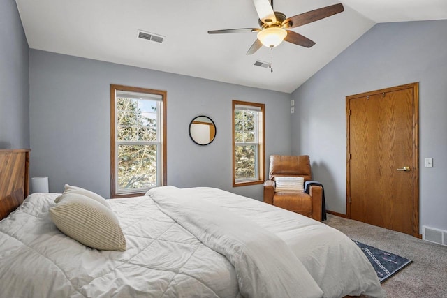 carpeted bedroom featuring ceiling fan, multiple windows, and lofted ceiling