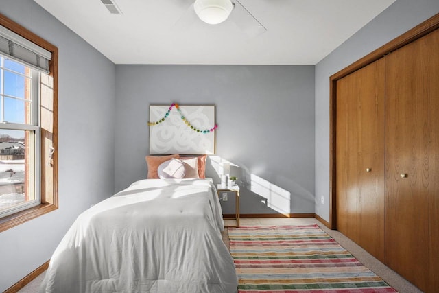 bedroom with ceiling fan and a closet