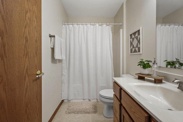 bathroom featuring toilet, vanity, and tile patterned flooring