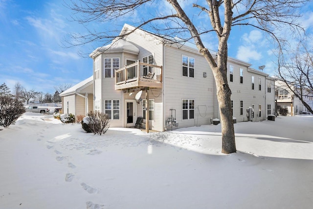 view of snow covered back of property