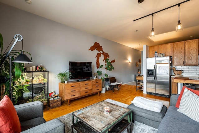 living room with lofted ceiling and light hardwood / wood-style floors