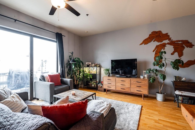 living room featuring ceiling fan and hardwood / wood-style floors