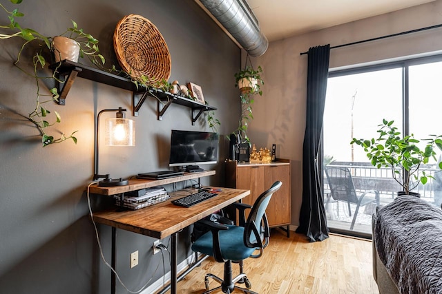 office space with a healthy amount of sunlight and light hardwood / wood-style floors