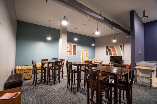 dining room featuring dark colored carpet