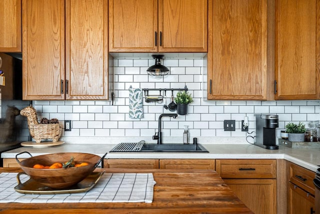 kitchen featuring tasteful backsplash and sink