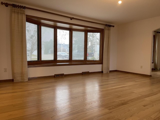 unfurnished room with light wood-type flooring