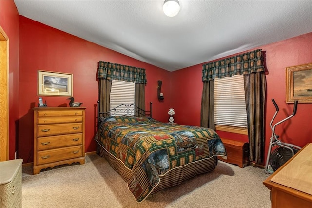 bedroom featuring vaulted ceiling and light carpet