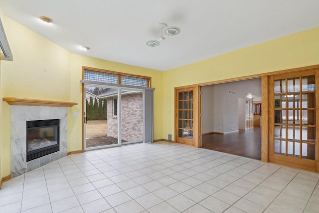 unfurnished living room with light tile patterned floors and a fireplace