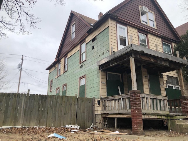 view of side of home with covered porch