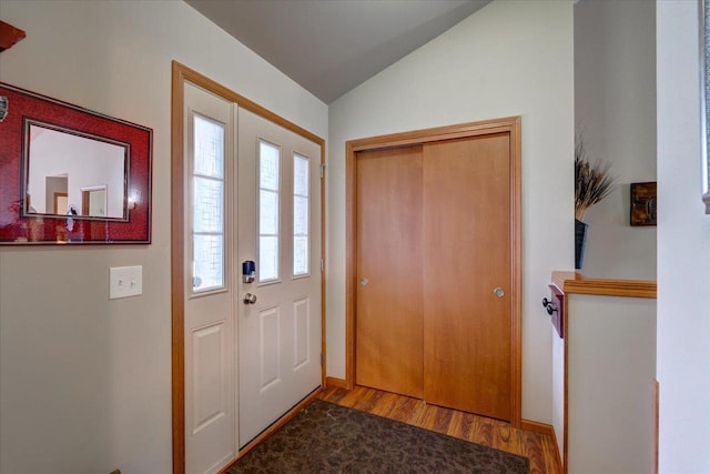 entrance foyer with vaulted ceiling and light wood-type flooring