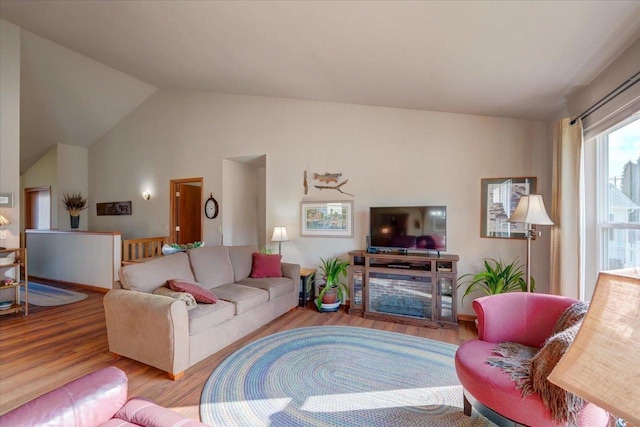 living room featuring lofted ceiling and hardwood / wood-style floors