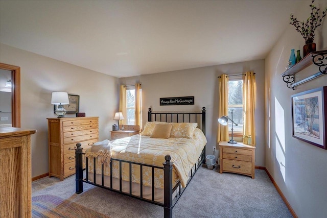 carpeted bedroom featuring multiple windows