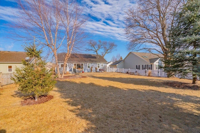 rear view of house with an outdoor structure and a lawn