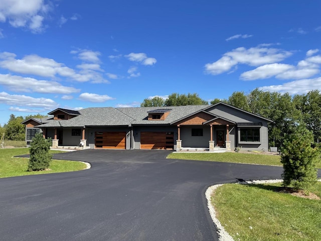 view of front of home with a garage and a front lawn