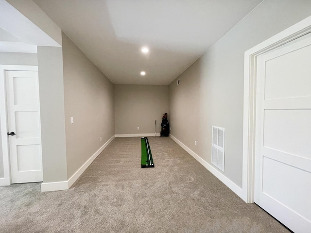 basement featuring light carpet