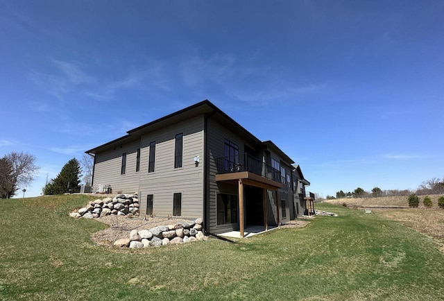 rear view of house featuring a lawn