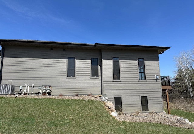 back of house featuring cooling unit and a yard