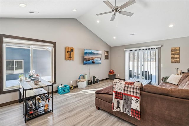 living room with light hardwood / wood-style flooring, high vaulted ceiling, and ceiling fan