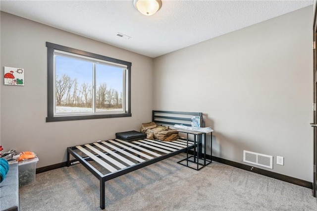 bedroom with a textured ceiling and carpet