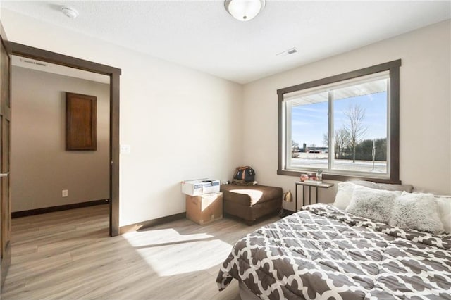 bedroom featuring a textured ceiling and light wood-type flooring