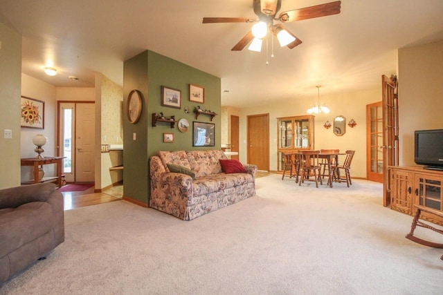 carpeted living room with ceiling fan