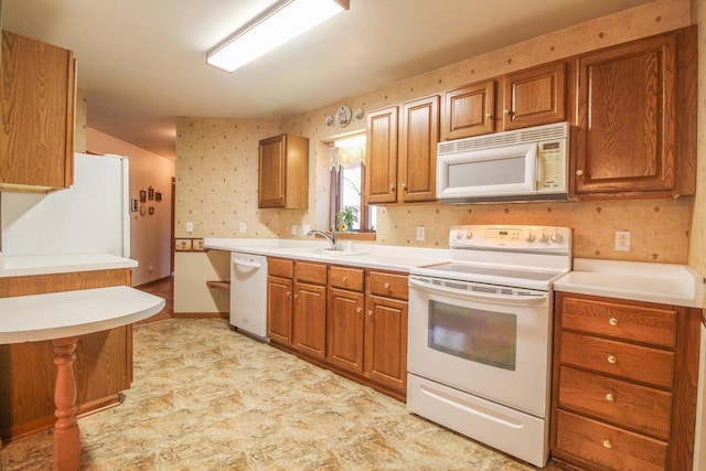 kitchen with sink and white appliances