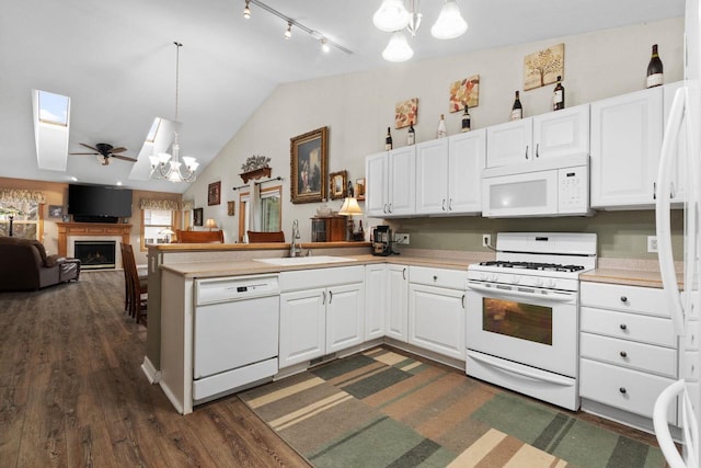 kitchen with sink, pendant lighting, white cabinets, and white appliances