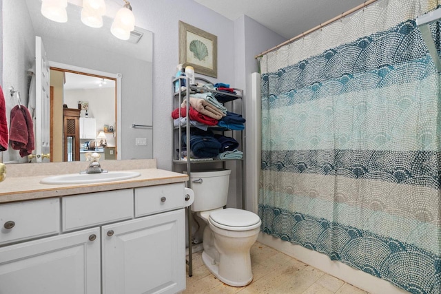 bathroom with vanity, toilet, and curtained shower