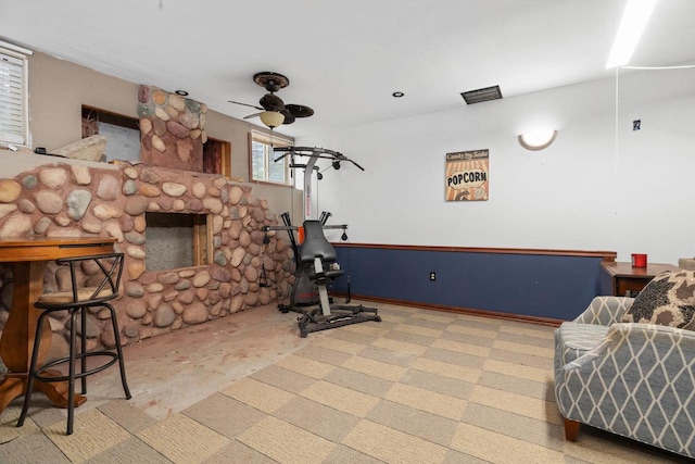 workout room featuring a fireplace