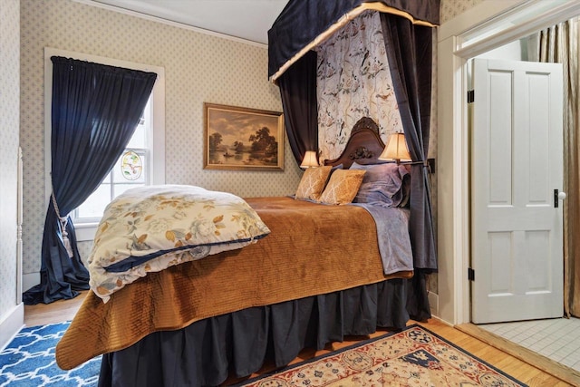 126 E Washington St, Stoughton, WI 53589 - bedroom with wood finished floors and wallpapered walls