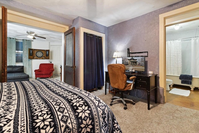 126 E Washington St, Stoughton, WI 53589 - bedroom with an office area, a textured wall, carpet, ensuite bath, and ceiling fan