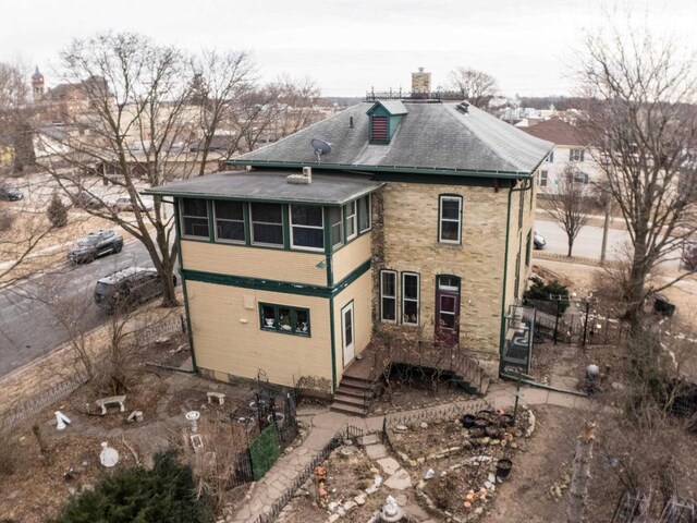 126 E Washington St, Stoughton, WI 53589 - back of house with a chimney and a shingled roof