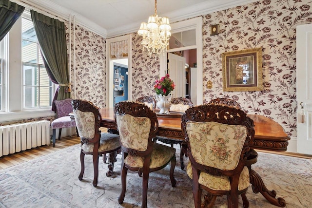 126 E Washington St, Stoughton, WI 53589 - dining space with wallpapered walls, a chandelier, crown molding, radiator, and plenty of natural light