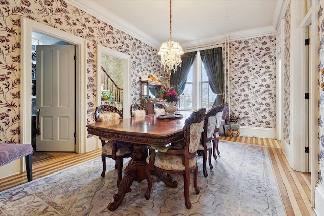 126 E Washington St, Stoughton, WI 53589 - dining room featuring wallpapered walls, a chandelier, light wood-style floors, ornamental molding, and baseboards