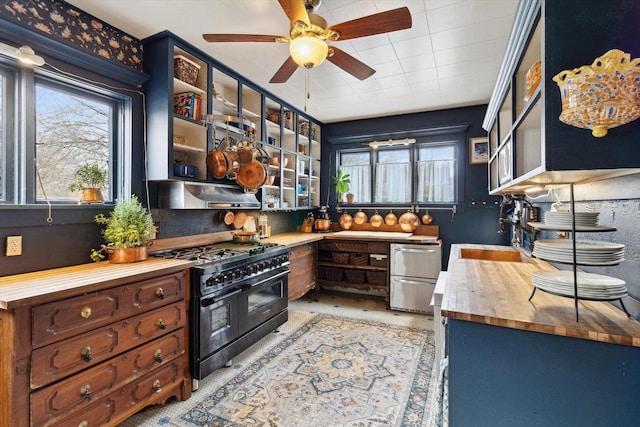 126 E Washington St, Stoughton, WI 53589 - kitchen featuring range with two ovens, wood counters, healthy amount of natural light, and a ceiling fan