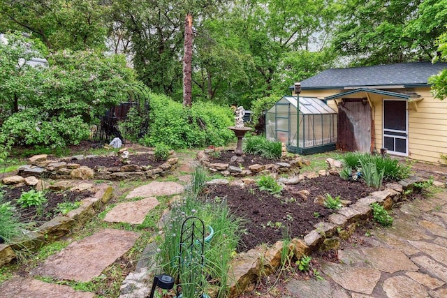 126 E Washington St, Stoughton, WI 53589 - view of yard featuring a greenhouse and an outdoor structure