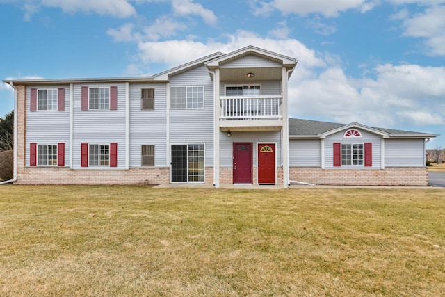 view of front of home featuring a balcony and a front lawn