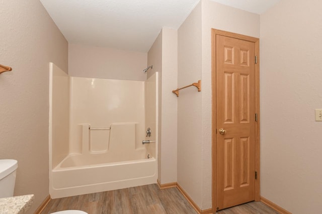 full bathroom featuring vanity, hardwood / wood-style flooring,  shower combination, and toilet