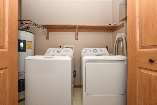 washroom with water heater and washer and dryer