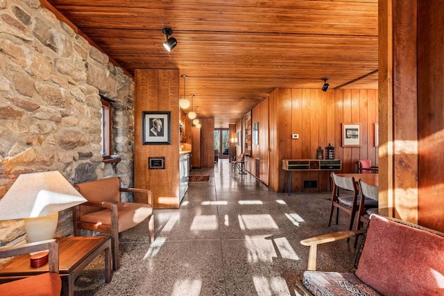 corridor featuring wood walls and wooden ceiling