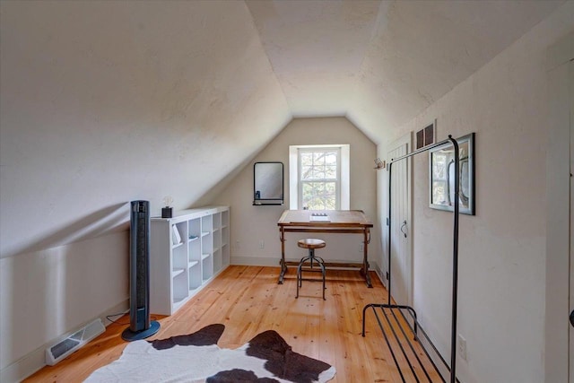 additional living space with lofted ceiling and wood-type flooring