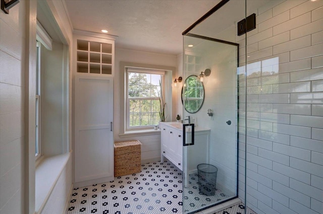 bathroom featuring vanity and a shower with shower door