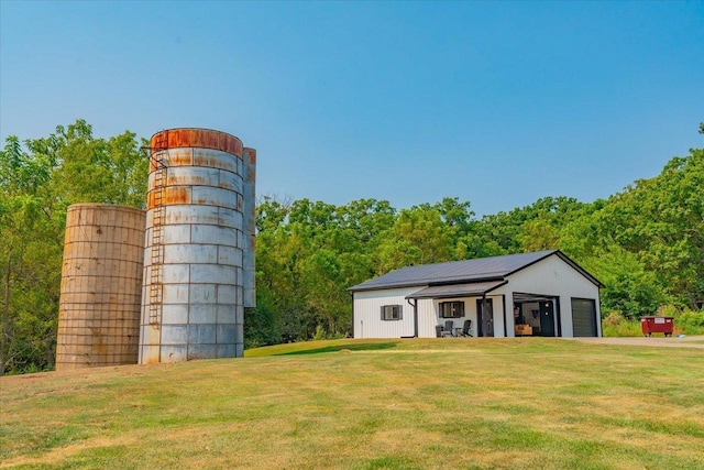 view of outdoor structure featuring a garage and a lawn