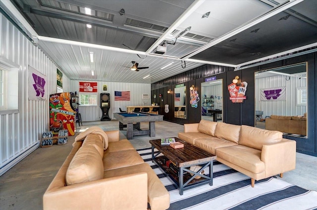 interior space featuring billiards, a baseboard radiator, and concrete flooring