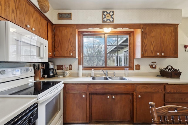 kitchen with sink and white appliances