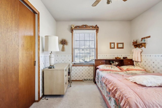 bedroom with light carpet and ceiling fan