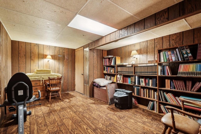 home office featuring hardwood / wood-style flooring and wood walls